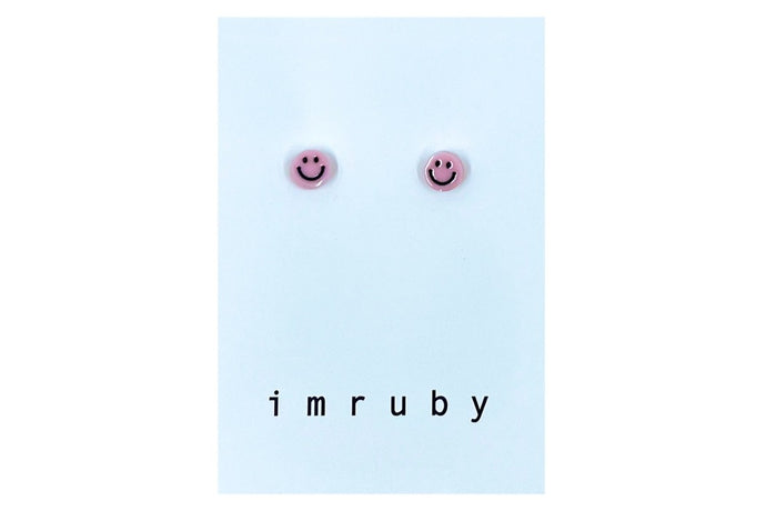 Hi! I'm ELLE, a soft pink smiley set of 2 stud earrings.  If you are looking for a perfect everyday staple, stud earrings may be exactly what you need! They are very tiny and so cute! These earring sets are perfect for numerous piercings or just to mix and match!   Packed in a reusable bag to keep your jewelry shiny and clean.