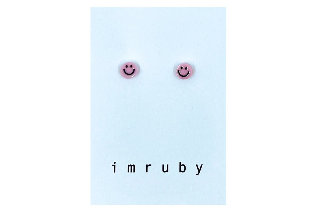 Hi! I'm ELLE, a soft pink smiley set of 2 stud earrings.  If you are looking for a perfect everyday staple, stud earrings may be exactly what you need! They are very tiny and so cute! These earring sets are perfect for numerous piercings or just to mix and match!   Packed in a reusable bag to keep your jewelry shiny and clean.