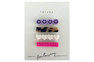 Hi! I'm a SET of 4 smiley clips.  (1 x Alice smiley, 1 x Lucy bar, 1 x Bonnie heart, 1 x Barbie bubble bar)  Hold back bangs, clip back hair, or simply use for stylistic purposes by adding some flair to your hair. Mix-and-match, and layer these hair clips or wear on their own for a soft, seasonal look.