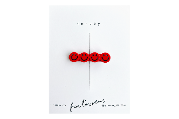 Red smiley face hair clip on a white card with 'imruby' branding.