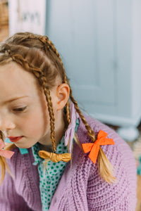 Hi! I'm IDA, a set of golden holographic candy bows.  Clip those little hairs back in style with this set of velvet candy bows. It features alligator clip backings for easy placement in any fun hairstyle. 