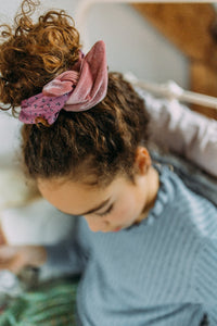 Hi! I'm DITA, a pink flower headband.  This headband has an aluminium wire insert for a comfortable & cute fit. Twist it around your girls head and she'll rock this pretty headband all day long!