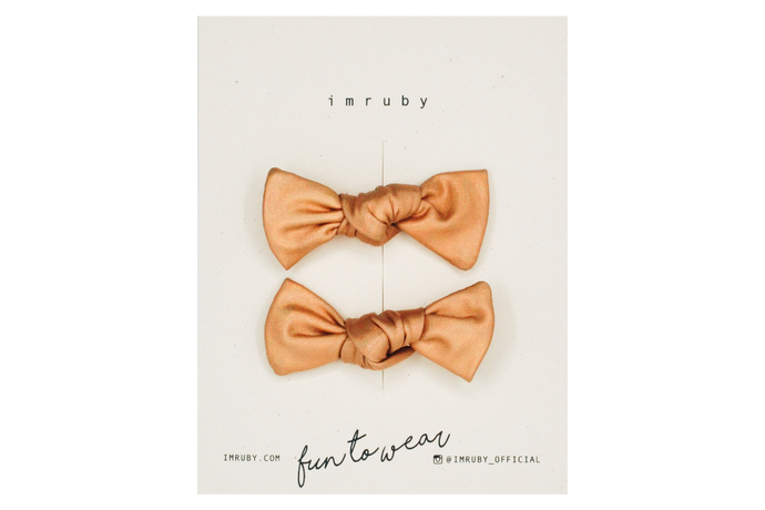 Hi! I'm IDA, a set of golden holographic candy bows.  Clip those little hairs back in style with this set of velvet candy bows. It features alligator clip backings for easy placement in any fun hairstyle. 