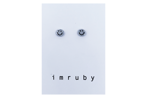 Hi! I'm BIBI, a silver glitter smiley set of 2 stud earrings.  If you are looking for a perfect everyday staple, stud earrings may be exactly what you need! They are very tiny and so cute! These earring sets are perfect for numerous piercings or just to mix and match! 