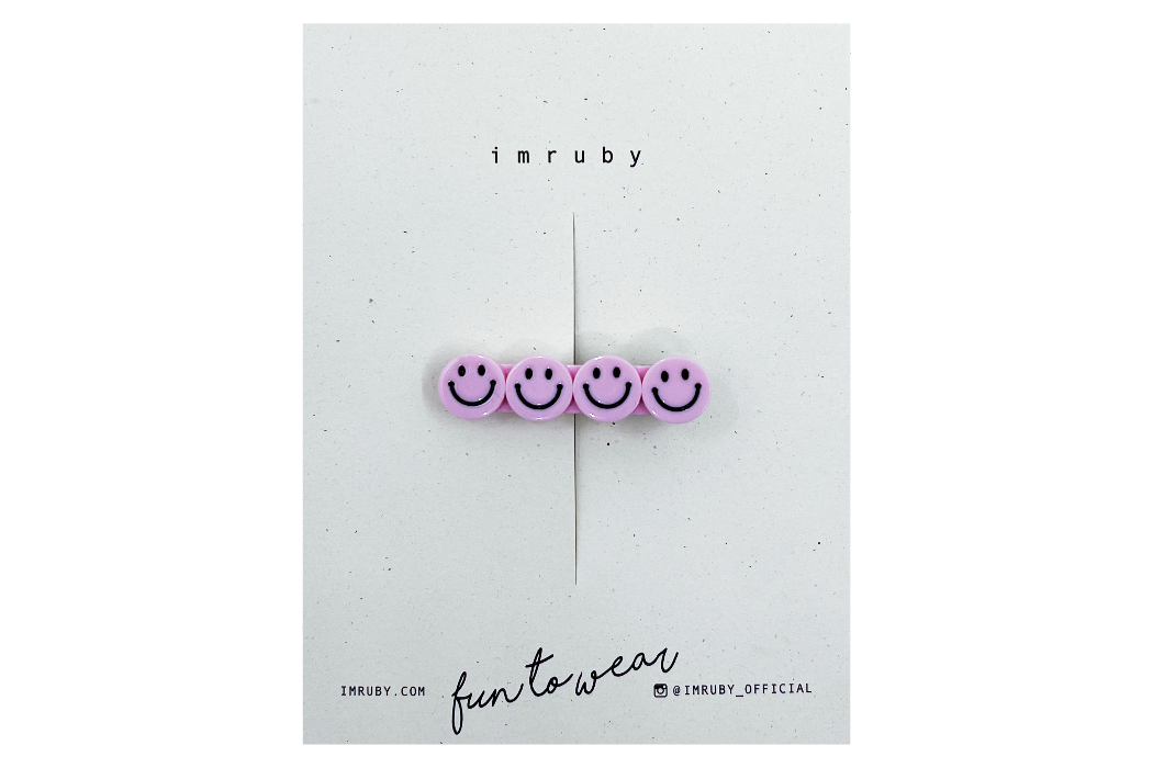 Hi! I'm ELLE, a soft pink smiley clip.  Hold back bangs, clip back hair, or simply use for stylistic purposes by adding some flair to your hair. Mix-and-match, and layer these hair clips or wear on their own for a soft, seasonal look.