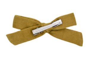 Hi! I'm JO, a moss green medium bow clip.  Add this charming bow to your hair to add some style and colour. This corduroy bow features an alligator clip for easy placement in any fun hairstyle.
